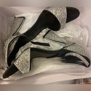 JLO women’s Irma Sandal, black rhinestone covered high heels.